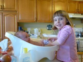 April 6, 2011 - Isabel helping give Sarah a bath