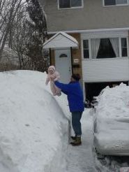 Mar 9/08 - Daddy putting Isabel in the snowbank